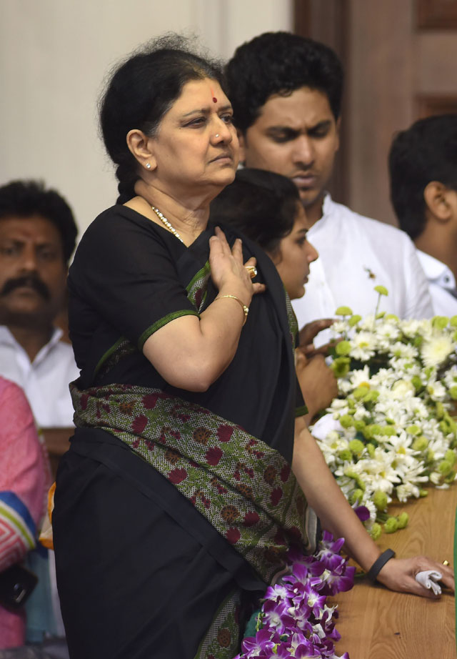 in this photograph taken on december 6 2016 close aide vk sasikala l stands next to the mortal remains of former chief minister of tamil nadu state jayalalithaa jayaram during her funeral in chennai photo afp