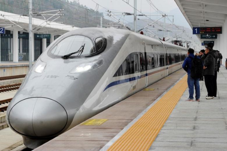 a high speed railway train linking shanghai and kunming of yunnan province is seen at a station during a partial operation in anshun guizhou province china photo reuters