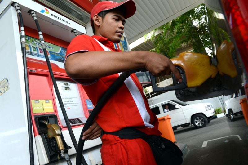 man fills petrol at a station photo afp