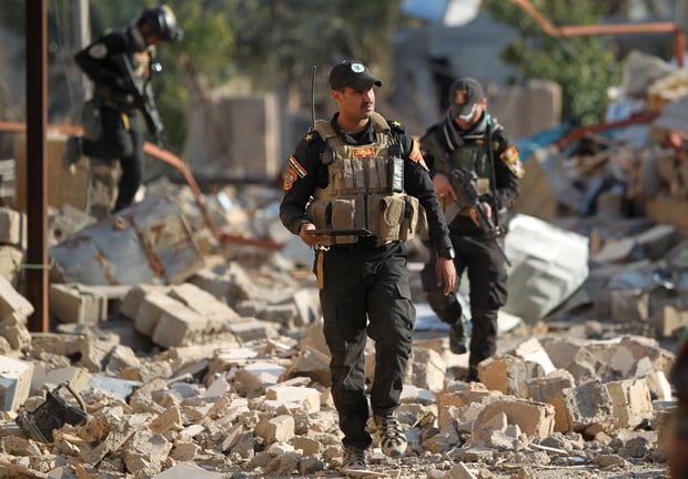 iraqi soldiers walks in rubble photo afp