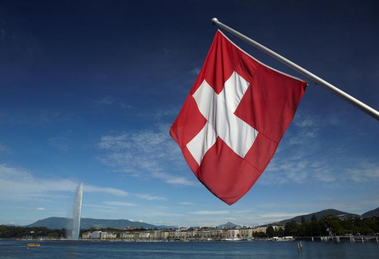 a swiss flag is pictured next to the jet d 039 eau water fountain and the lake leman from the st pierre cathedrale in geneva switzerland photo reuters