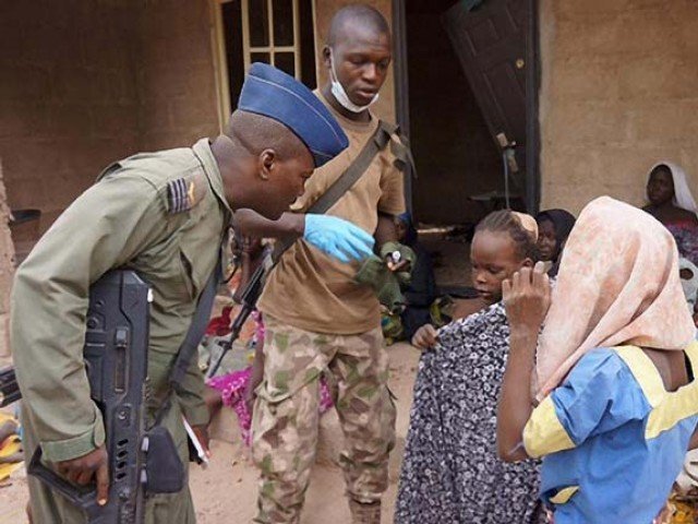 nigerian soldiers talk to girls rescued during an operation against boko haram militants in the sambisa forest borno state in april 2015 photo afp