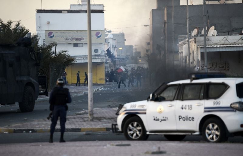 protesters throw stones towards riot police during clashes in the shiite village of shahrakkan photo afp