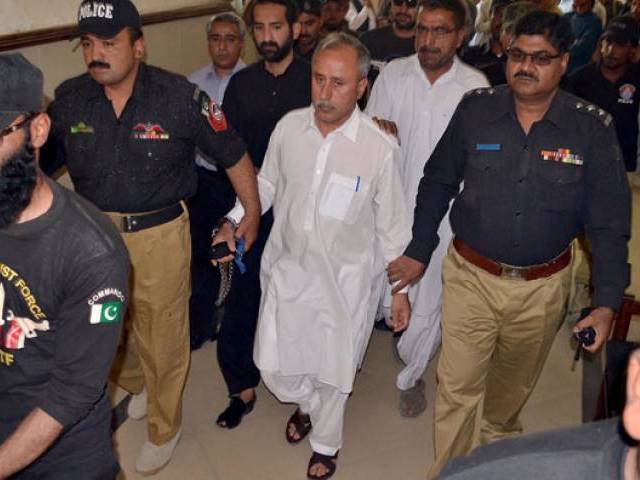 police escort former finance secretary balochistan mushtaq raisani out of an accountability court in quetta on may 7 2016 photo inp