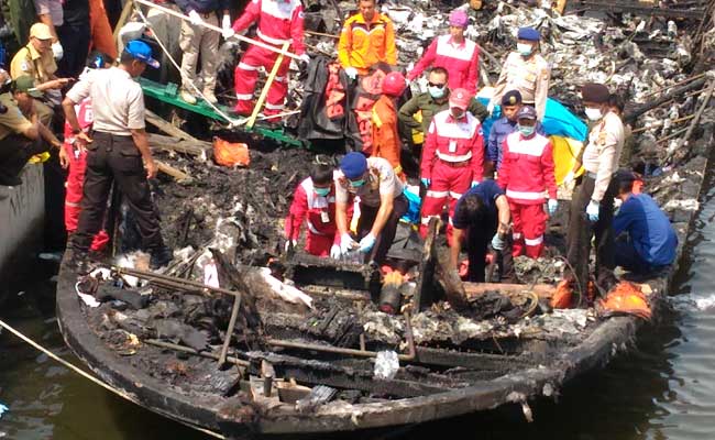 rescuers search for bodies on the charred passenger boat zahro express photo afp