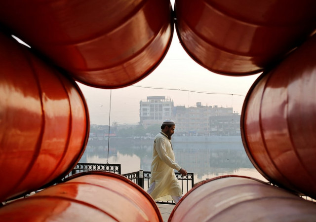 a man walks on the promenade next to a lake in mumbai india photo afp