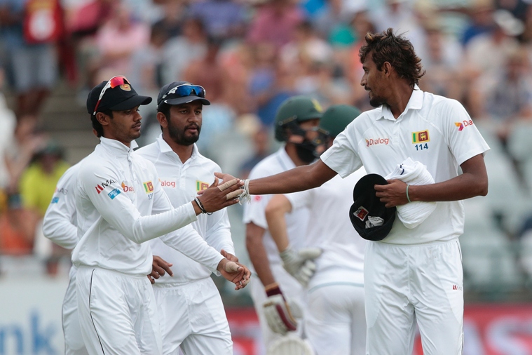 sri lanka bowler suranga lakmal r is congratulated by teammates as he walks the field during a bowling change during the second test between south africa and sri lanka on january 2 2017 at newlands cricket stadium in cape town south africa photo afp