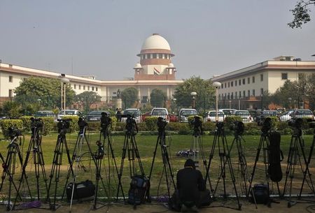 a television journalist sets his camera inside the premises of the supreme court in new delhi photo reuters