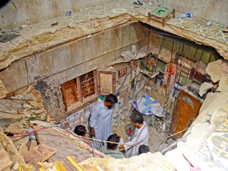 around 20 people including six children and four women were injured when the roof of a house collapsed in chanesar goth photo muhammad noman express