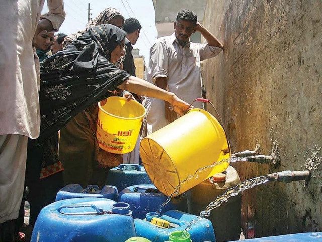 people filling water bottles from a pumping station in baldia town due to the acute water shortage in the city photo file people filling water bottles from a pumping station in baldia town due to the acute water shortage in the city photo file