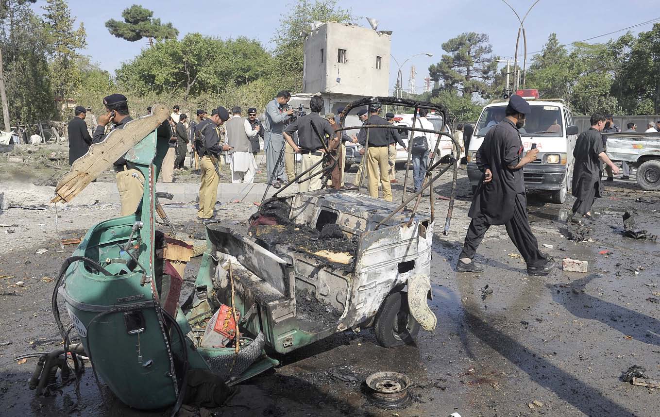 security officials examine the site of the twin suicide bomb attack that wreaked carnage in the capital of the restive province photo file