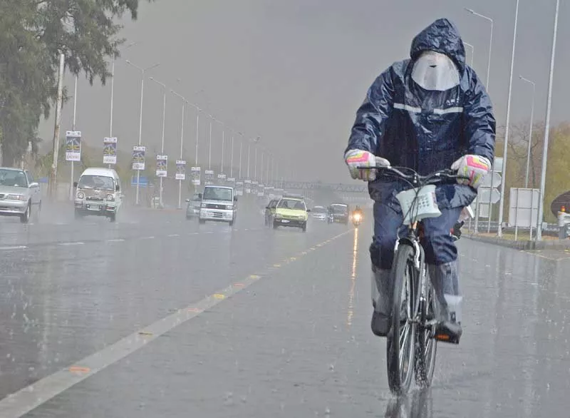 a cyclist pedals along the islamabad highway during rain photo mudassar raja express a cyclist pedals along the islamabad highway during rain photo mudassar raja express