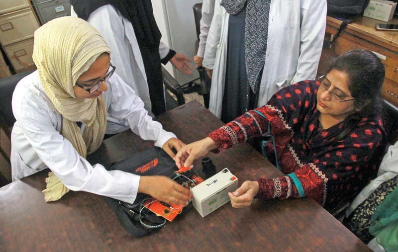 a team of researchers displays the heart attack detection device at karachi university photo athar khan express