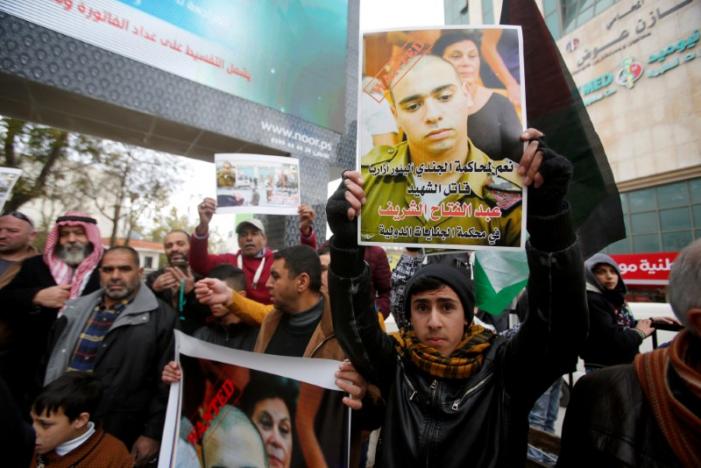 a palestinian holds a poster of israeli sergeant elor azaria that reads quot wanted quot during a protest in the west bank city of hebron january 4 2017 photo reuters