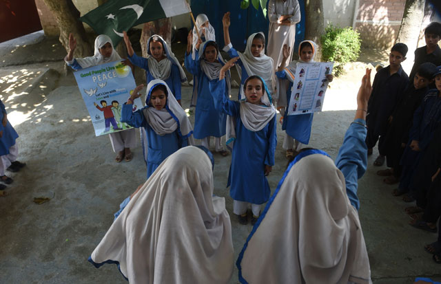 in this photograph taken on august 30 2016 hindko speaking schoolchildren sing the national anthem at their school in mansehra around a hundred women have gathered in a community centre in peshawar the heart of pakistan 039 s fabled northwest    but they are conversing in a dialect incomprehensible to the pashtun ethnic group that dominates the region photo afp