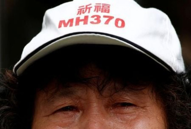 a family member of a passenger aboard malaysia airlines flight mh370 wearing a hat that reads quot pray for mh370 quot photo reuters a family member of a passenger aboard malaysia airlines flight mh370 wearing a hat that reads quot pray for mh370 quot photo reuters
