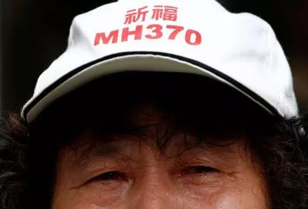 a family member of a passenger aboard malaysia airlines flight mh370 wearing a hat that reads quot pray for mh370 quot photo reuters a family member of a passenger aboard malaysia airlines flight mh370 wearing a hat that reads quot pray for mh370 quot photo reuters