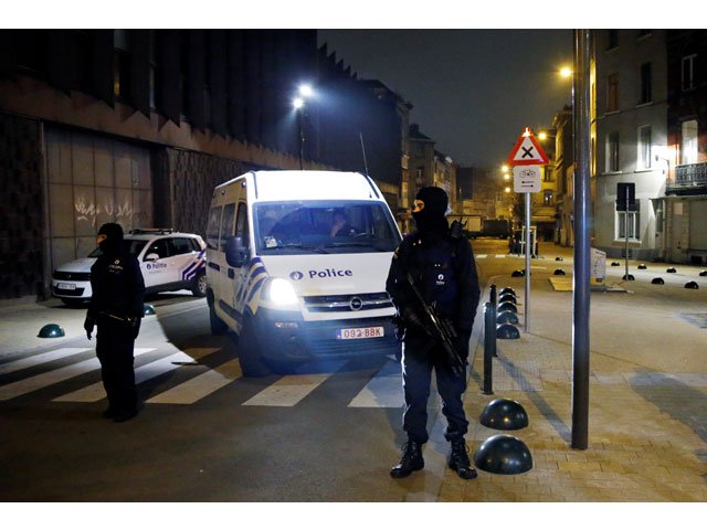 belgian police officers stand guard at the scene of a security operation in the brussels district of molenbeek belgium march 18 2016 photo reuters