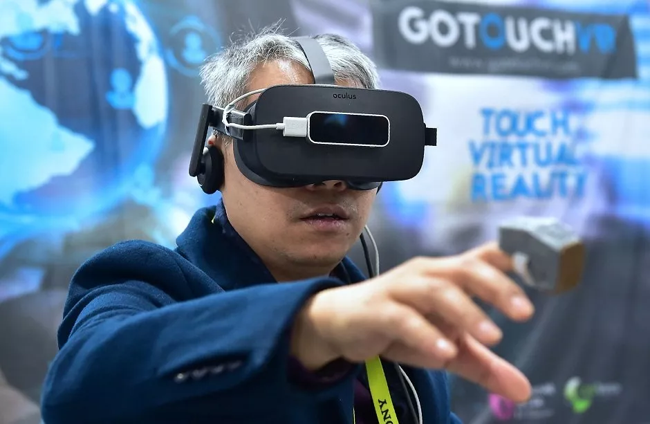 an attendee samples vr touch from gotouchvr a wearable haptic ring creating the illusion of touching virtual objects designed and available for a large variety of applications is displayed at the 2017 consumer electronic show ces in las vegas nevada photo afp an attendee samples vr touch from gotouchvr a wearable haptic ring creating the illusion of touching virtual objects designed and available for a large variety of applications is displayed at the 2017 consumer electronic show ces in las vegas nevada photo afp
