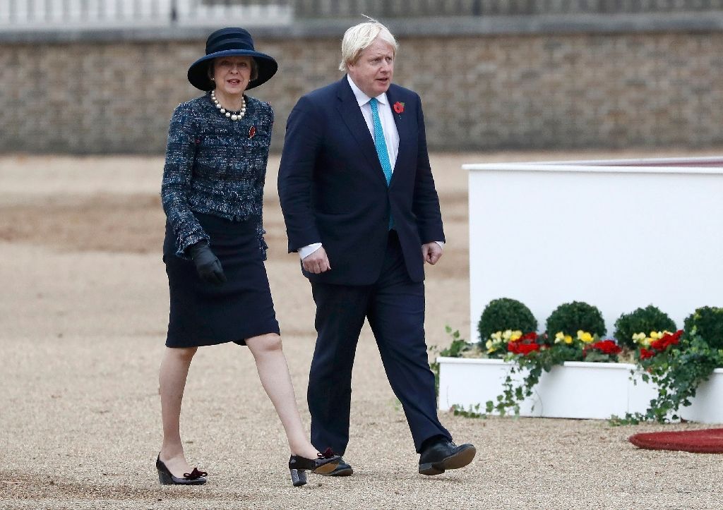 britain 039 s prime minister theresa may l and british foreign secretary boris johnson arrive to take part in a ceremonial welcome at horse guards parade photo afp