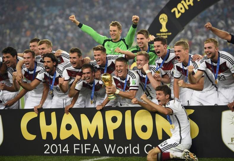 germany 039 s bastian schweinsteiger holds the world cup trophy as his teammates celebrate after winning the 2014 world cup against argentina at the maracana stadium in rio de janeiro july 13 2014 photo reuters