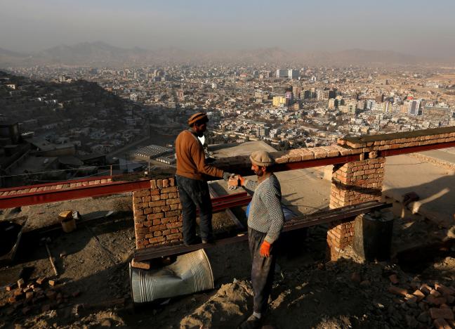 afghan men build a house on a hilltop overlooking kabul afghanistan january 1 2017 photo reuters