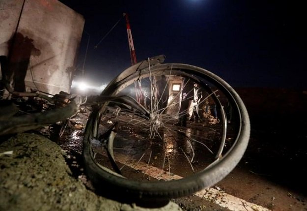 a bicycle lies on the ground as policemen keep watch at the site of suicide attack in kabul afghanistan january 10 2017 photo reuters