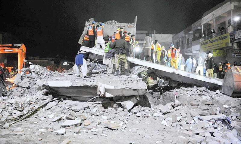 rescue workers are busy clearing the debris of the collapsed building photo app