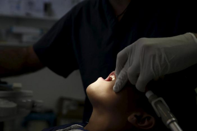 dentist christos naoumis treats a young boy at the doctors of the world polyclinic in central athens greece october 27 2015 picture taken october 27 2015 reuters alkis konstantinidis dentist christos naoumis treats a young boy at the doctors of the world polyclinic in central athens greece october 27 2015 picture taken october 27 2015 reuters alkis konstantinidis
