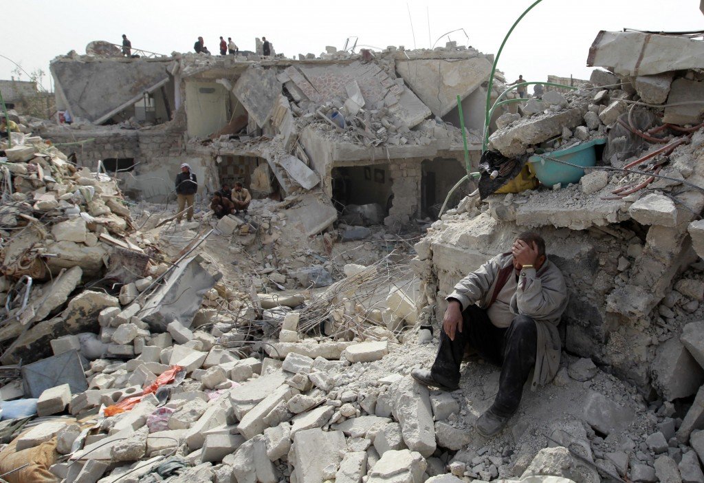 a man at a site hit by missile in aleppo s ard al hamra neighborhood photo reuters