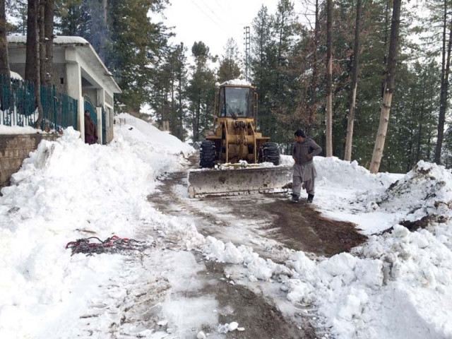 bulldozer is used to remove snow from a road in nathiagali photo express bulldozer is used to remove snow from a road in nathiagali photo express
