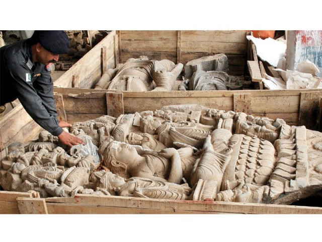 a policeman looks at a sculpture found from warehouse photo athar khan express a policeman looks at a sculpture found from warehouse photo athar khan express