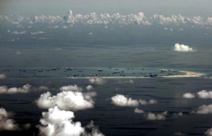 file photo   an aerial photo taken though a glass window of a philippine military plane shows the alleged on going land reclamation by china on mischief reef in the spratly islands in the south china sea west of palawan philippines may 11 2015 reuters ritchie b tongo file photo