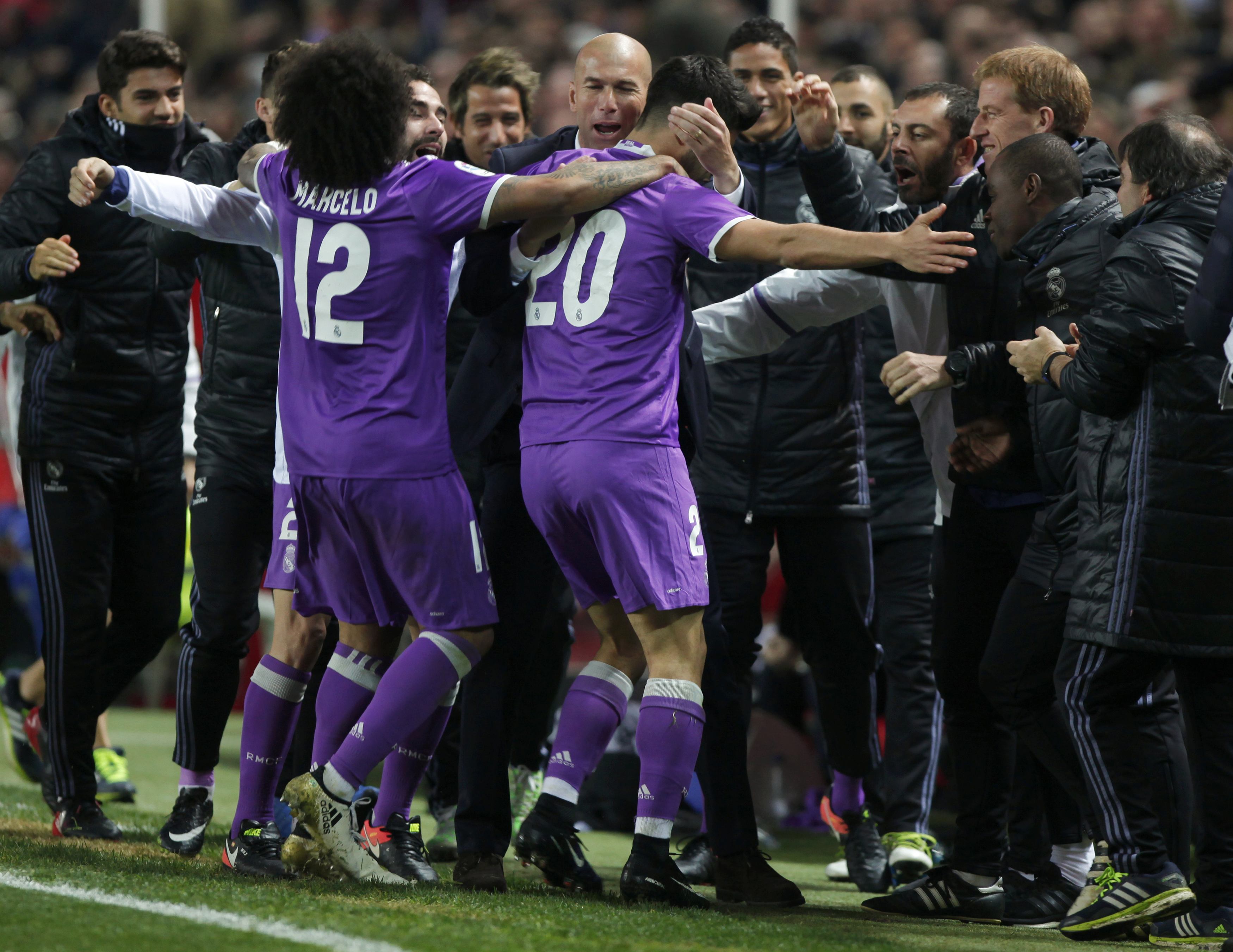 real madrid 039 s marco asensio c is congratulated by coach zinedine zidane after scoring his first goal against sevilla on january 12 2016 photo reuters