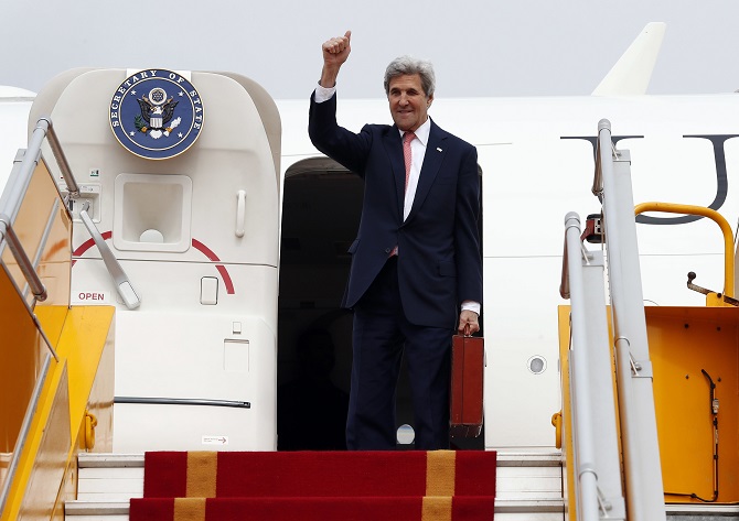 secretary of state john kerry waves as he boards his plane at hanoi airport on january 13 2017 photo afp