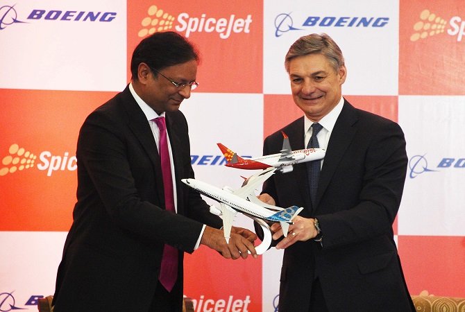 spicejet chairman ajay singh l and raymond l conner r vice chairman of boeing exchange model planes at a press conference in new delhi on january 13 2017 photo afp