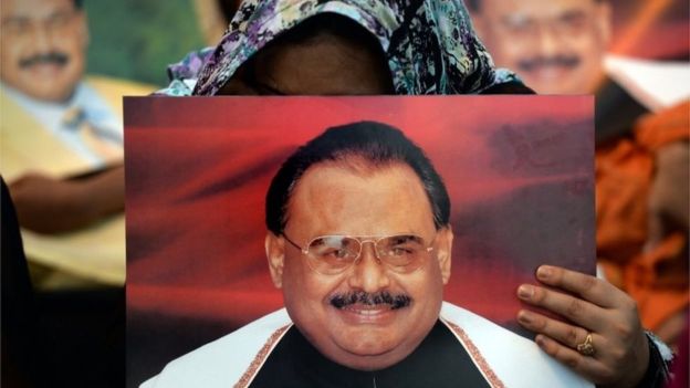 a woman holds a poster of mqm leader altaf hussain photo reuters