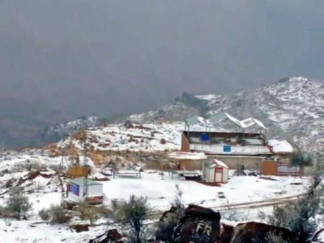 a blanket of snow covers hills around fort munro below people enjoy the first snowfall of the winter season photo tariq ismaeel express