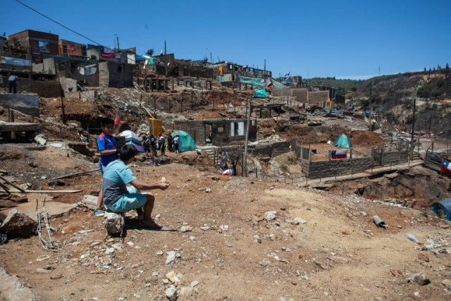 local residents live in tents while they work to rebuild after the damage caused by the january 2 forest fire in puertas negras valparaiso chile photo afp local residents live in tents while they work to rebuild after the damage caused by the january 2 forest fire in puertas negras valparaiso chile photo afp