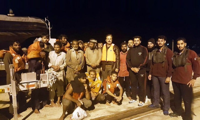 the rescued fisherman are photographed with pakistan navy officials after the successful operation photo pakistan navy the rescued fisherman are photographed with pakistan navy officials after the successful operation photo pakistan navy