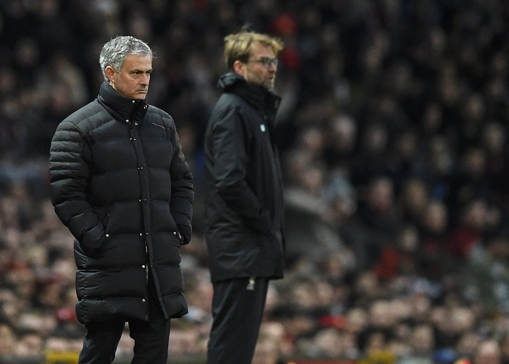 jose mourinho l and jurgen klopp watch the players from the touchline on january 15 2017 photo afp