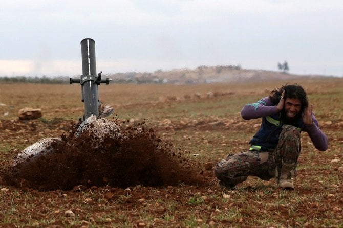 a rebel fighter reacts as he fires his weapon as rebels advance towards the northern syrian town of al bab syria january 15 2017 photo reuters