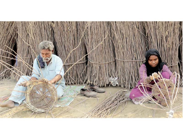 a couple busy in preparing wooden baskets to earn a livelihood for their family in hyderabad photo ppi a couple busy in preparing wooden baskets to earn a livelihood for their family in hyderabad photo ppi