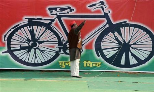 a samajwadi party worker gestures in front of a banner with the party 039 s electoral symbol the bicycle photo reuters a samajwadi party worker gestures in front of a banner with the party 039 s electoral symbol the bicycle photo reuters