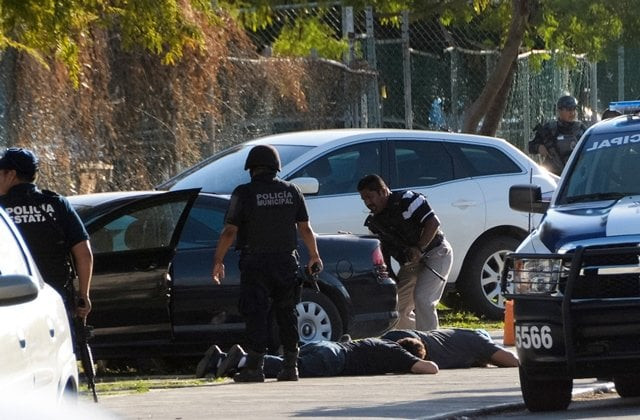 a marine arrives at the place where a shooting erupted after an attack against the building of the quintana roo state prosecution in cancun mexico on january 17 2017 photo afp a marine arrives at the place where a shooting erupted after an attack against the building of the quintana roo state prosecution in cancun mexico on january 17 2017 photo afp