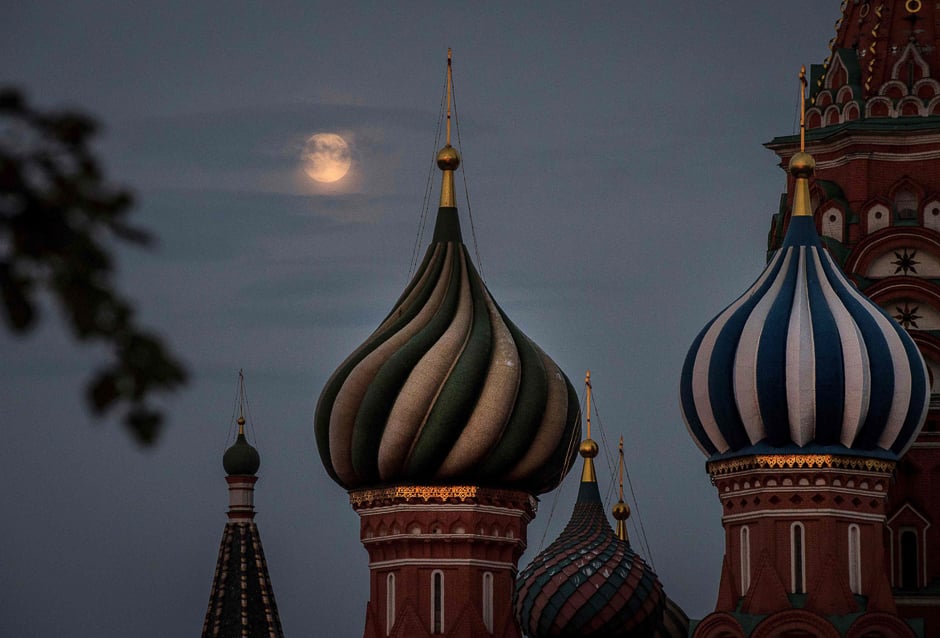 The full moon rises behind St Basil's Cathedral at the Red Square in Moscow. PHOTO: AFP