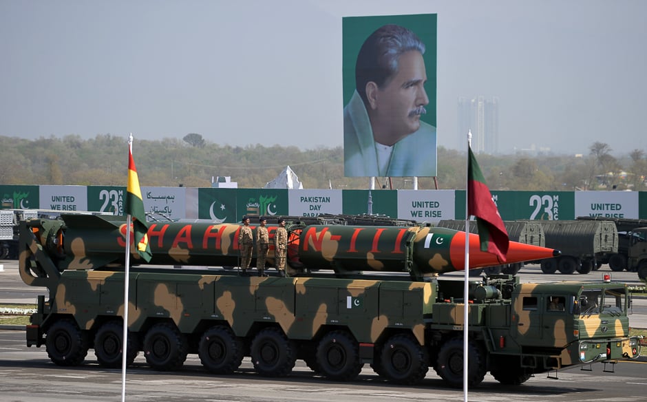 Military personnel stand beside a Shaheen III surface-to-surface ballistic missile during a Pakistan Day military parade in Islamabad. PHOTO: AFP