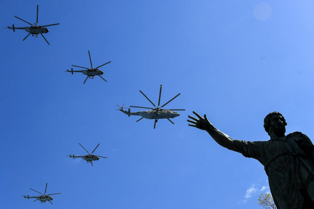 russian mi 8 and mi 26 helicopters fly over red square during a rehearsal for the victory day military parade in moscow photo afp