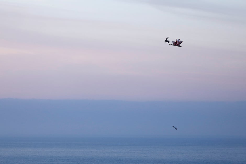 A 10-foot long remote controlled flying Santa makes a test flight over the ocean in Carlsbad, California, US. PHOTO: REUTERS