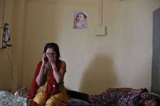 a surrogate mother speaks on a mobile phone with her husband inside the clinic of akanksha ivf center in anand town about 70 km 44 miles south from the western indian city of ahmedabad august 27 2013 photo reuters a surrogate mother speaks on a mobile phone with her husband inside the clinic of akanksha ivf center in anand town about 70 km 44 miles south from the western indian city of ahmedabad august 27 2013 photo reuters